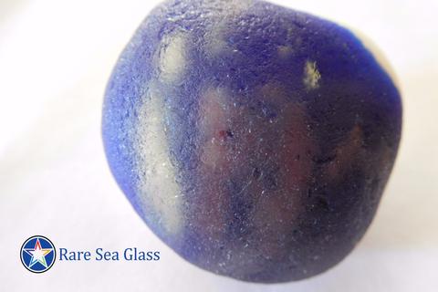 Sea glass piece from Davenport Beach with world globe pattern showing continent outlines